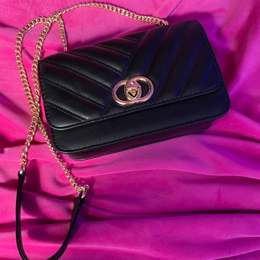 Black crossbody bag with gold accent chain